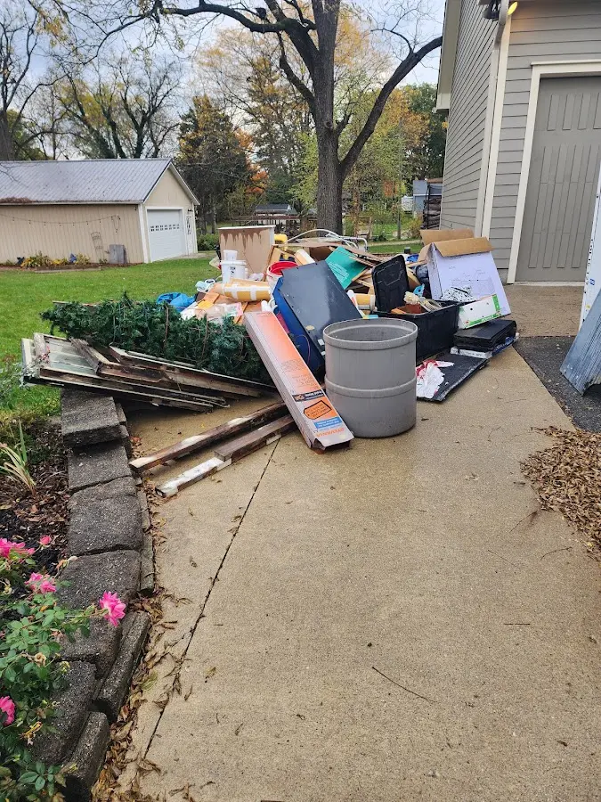 Dumpster being loaded with debris for Estate Cleanout Dumpster Rental in Fort Hood